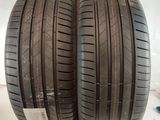 two tires are stacked on top of each other on a white surface