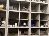 a room with a lot of shelves and bins on it