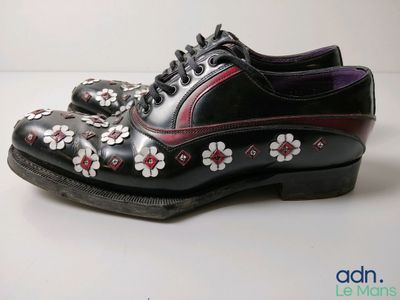 a close up of a pair of shoes with flowers on them