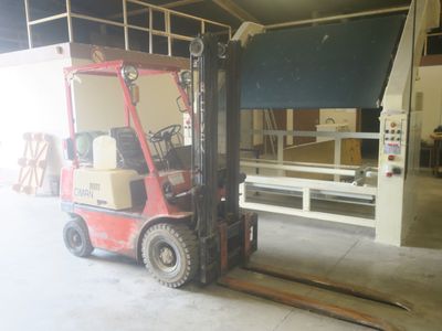 a forklift truck that is parked in a garage