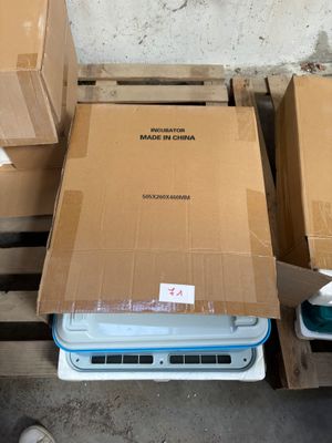 several boxes of electronic equipment are stacked on pallets in a warehouse