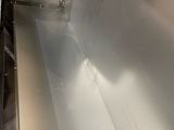 a stainless steel sink in the middle of a kitchen