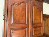 a large wooden cabinet in the corner of a room