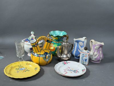 many different types of vases and plates on the table