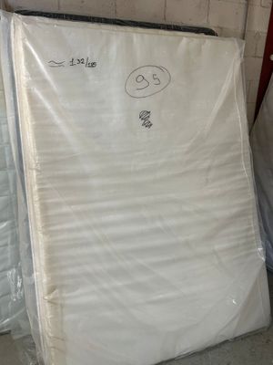 many mattresses in the warehouse for sale on the floor