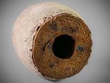 a close up of a vase with a hole in it