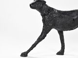 a black statue of a dog on a white background