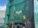 a large green truck that is parked on the side of the road