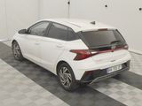 a white car parked in a garage with a checkered floor