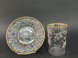 two cups and a saucer sitting next to each other