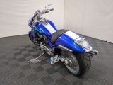 a blue motorcycle that is parked in a room