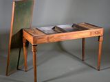 a small wooden desk with a mirror on top of it