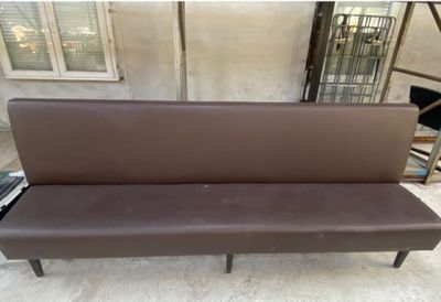 a brown bench that is sitting on the ground