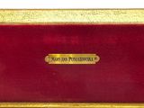 an image of a gold and red box with a nameplate on it