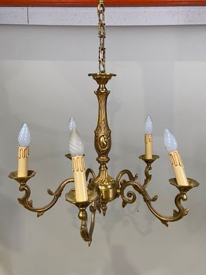 a gold chandelier with five lights hanging from it