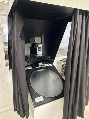 une photo en noir et blanc d'un téléviseur dans une pièce avec des rideaux