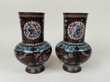 two vases that are sitting on a table