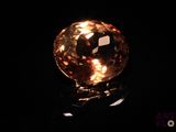 a close up of a yellow diamond on a black surface