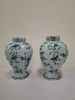 pair of blue and white vases sitting on top of a white table