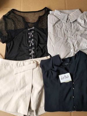 three pieces of clothing in a box on the floor