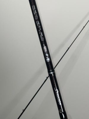 a close up of a fishing rod on a white surface
