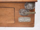 a wooden box with a metal latch on it