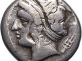 a silver coin with a woman ' s head on it