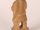 statue of a man with a hat on his head and a backpack on his back
