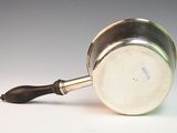 a silver pot with a handle on a white surface