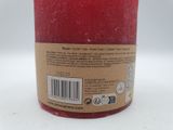 a red candle that is sitting on a table