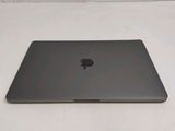 an apple macbook pro laptop computer sitting on a white surface