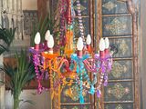 a colorful chandelier hanging from the ceiling in a living room