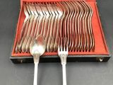 silverware in a case on a table with spoons and forks in it