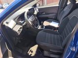 the interior of a blue car with black seats and a steering wheel