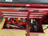 a red tool box with tools in it on the floor