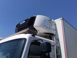 a white truck with luggage on top of it