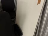 a black chair sitting in front of a white board