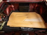 the trunk of a red car with its hood open and the hood down