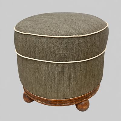 the foot stool is made of wood and has a grey fabric