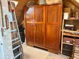 a ladder leaning against a wooden cabinet in a room