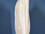 white shirt on a mannequin stand against a blue wall