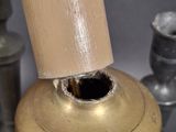 a metal object that has a wooden handle on it