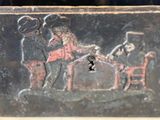 a black box with a painting of a man and a woman playing a game of cards