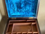 a wooden box with a blue velvet lining inside