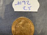 a close up of a gold coin with a label on it