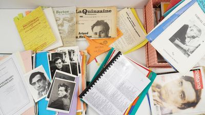 a box full of books and papers on a table