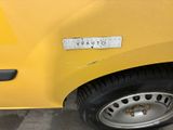 a close up of a yellow car with a sticker on it