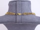 a close up of a mannequin hat with a chain around it