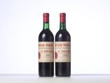 two bottles of red wine sitting next to each other on a table