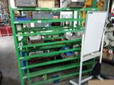 a green rack with a white board on it